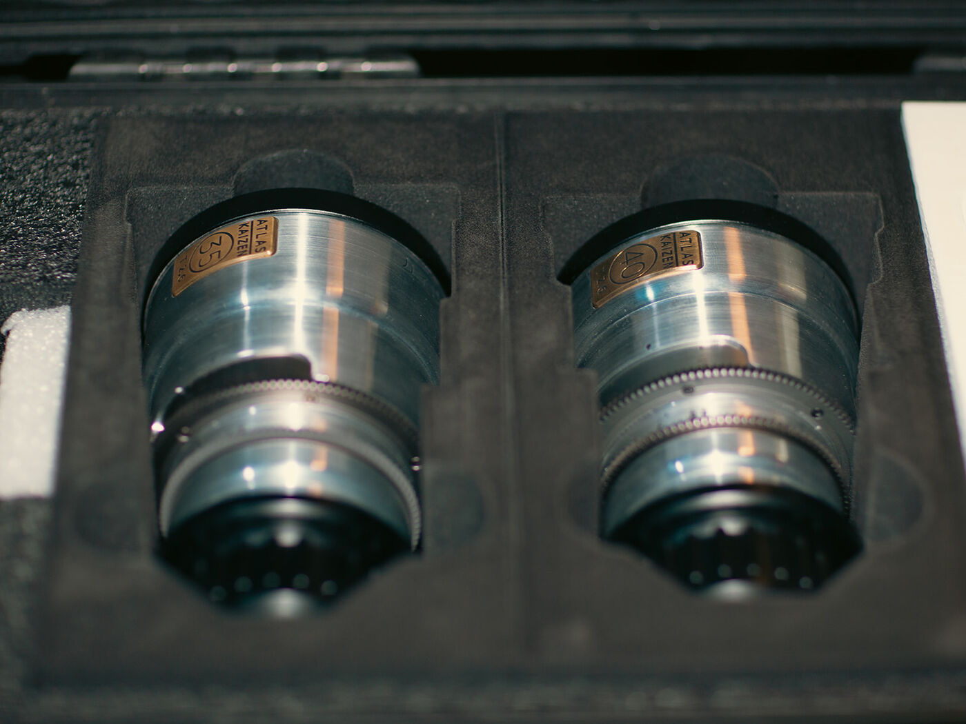 A pair of cinema lenses laid open in their case