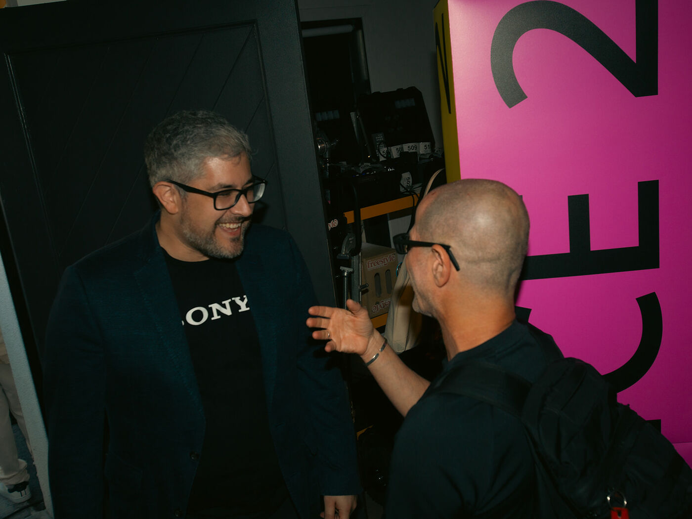 Two guests talking, one in a Sony shirt